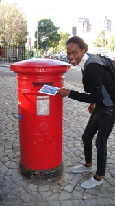 Juvelina sending a postcard to Angola