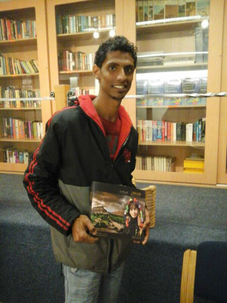 Ahmed Bafgeesh donating his book to EC Cape Town's Library